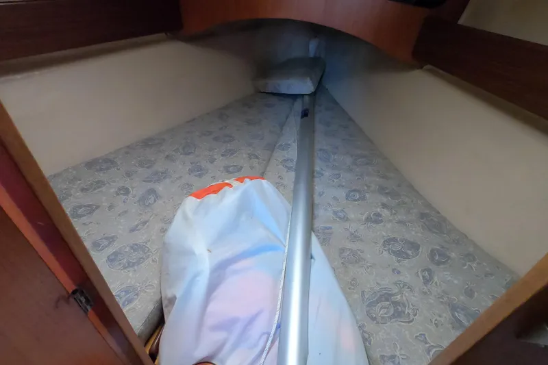 Slide: The Image of Interior cabin of 1985 Beneteau First 29 sailboat with patterned bedding. - 21