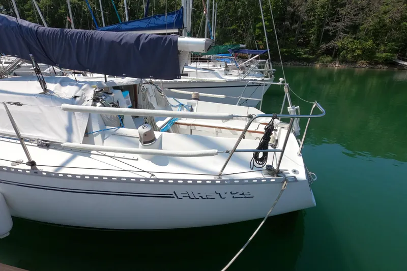 Slide: The Image of 1985 Beneteau First 29 sailboat docked in serene marina setting. - 4