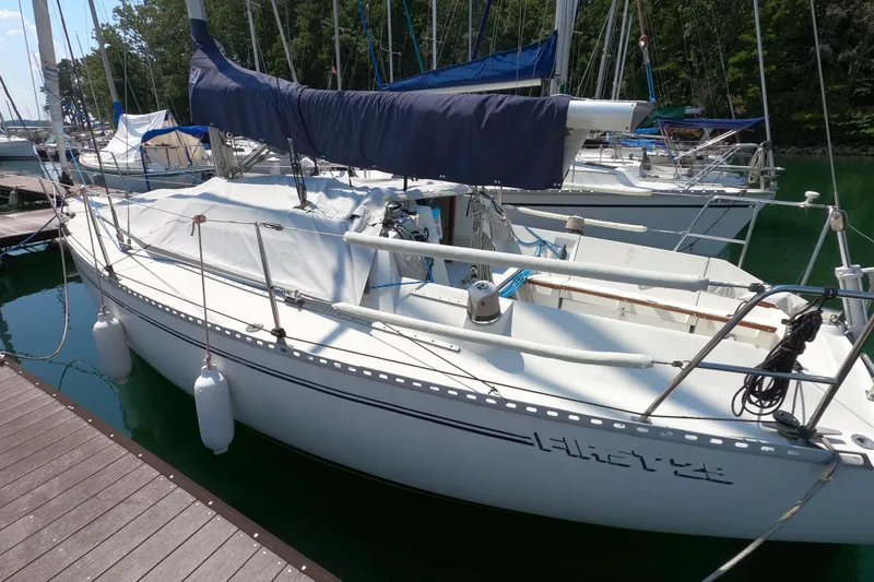 Slide: The Image of 1985 Beneteau First 29 sailboat docked at marina, covered and ready for sailing. - 5