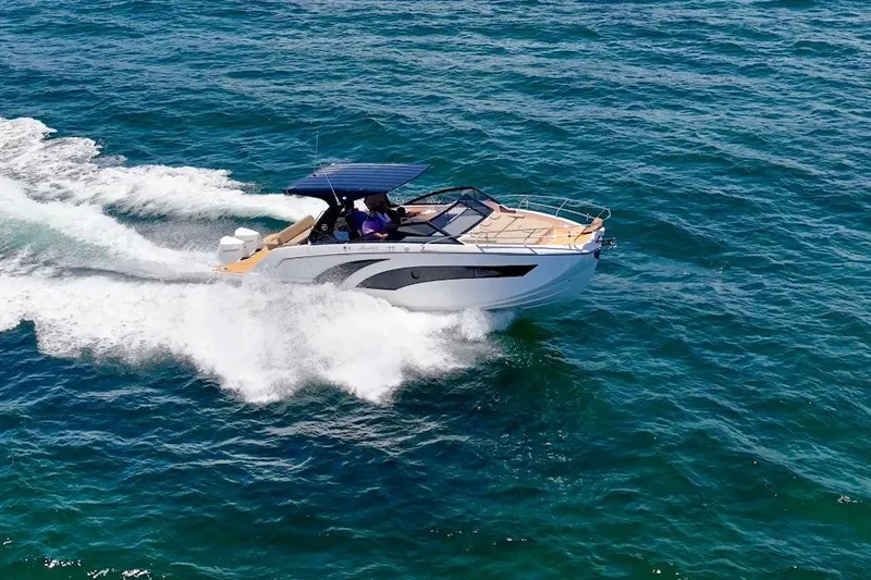 Slide: The Image of 2024 Hanover 347 White & Black Edition boat cruising on open sea. - 4
