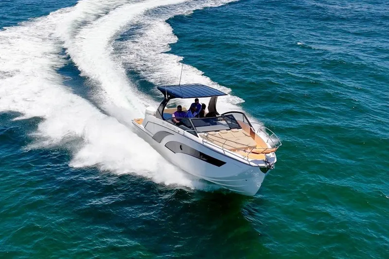 Slide: The Image of 2024 Hanover 347 White & Black Edition boat cruising on open water. - 5
