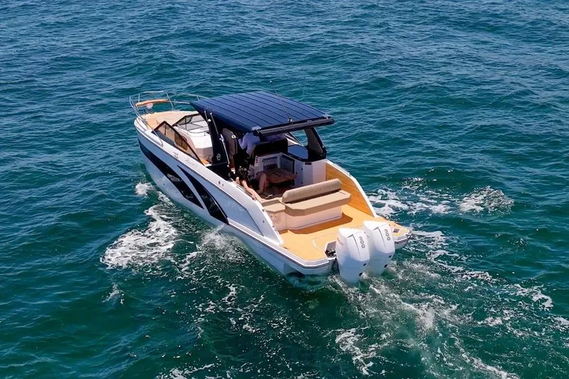 Slide: The Image of 2024 Hanover 347 White & Black Edition boat cruising on open water. - 6