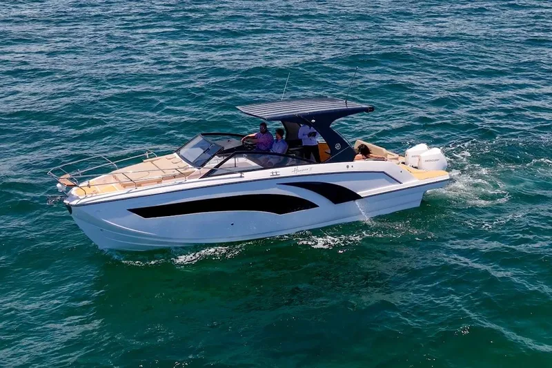 Slide: The Image of 2024 Hanover 347 White & Black Edition boat cruising on open water. - 7