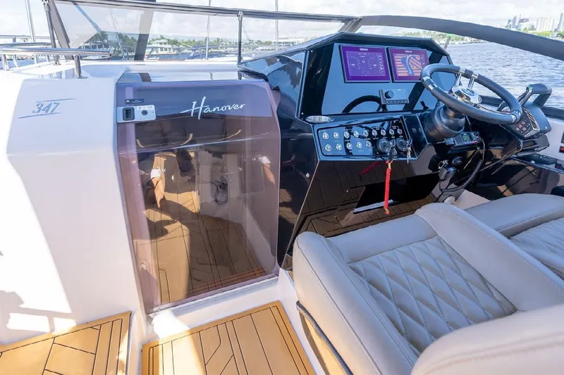 Slide: The Image of 2024 Hanover 347 White & Black Edition yacht cockpit with modern controls and luxurious seating. - 8