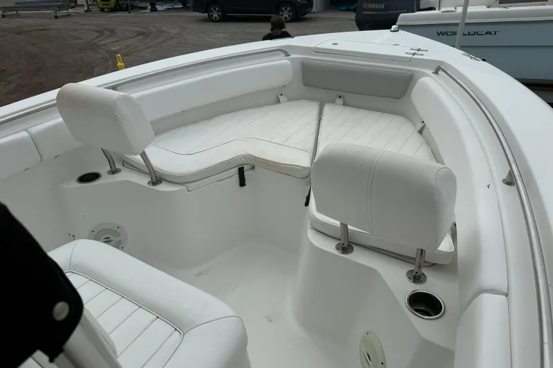 Slide: The Image of 2013 Sea Hunt Triton 210 boat interior with white cushioned seating. - 12