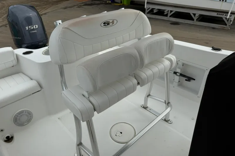 Slide: The Image of 2013 Sea Hunt Triton 210 boat interior with white seating and Yamaha 150 engine. - 13