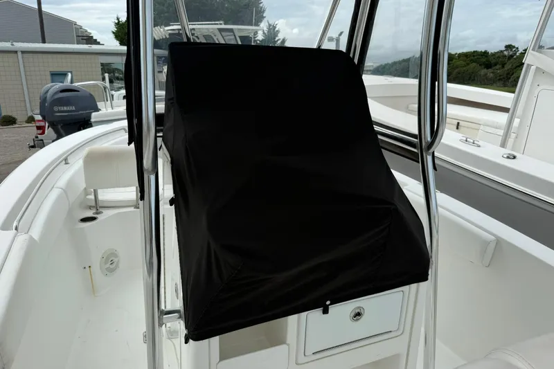 Slide: The Image of 2013 Sea Hunt Triton 210 boat interior with covered console and Yamaha outboard motor. - 15