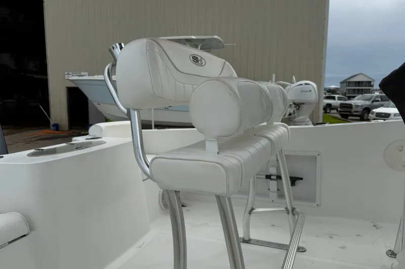 Slide: The Image of 2013 Sea Hunt Triton 210 boat with white cushioned seating and stainless steel frame. - 7