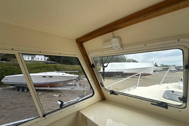 Slide: The Image of Interior view from 2013 Eastern Explorer 248 boat, overlooking parked boats and countryside. - 16
