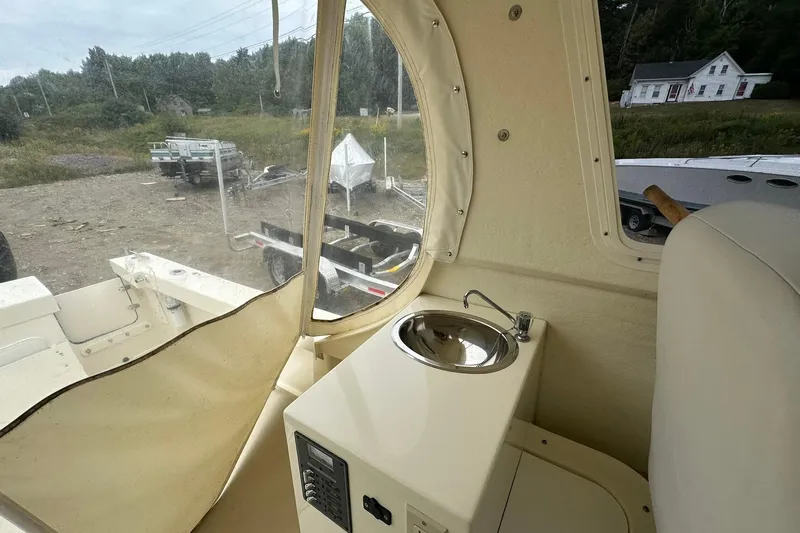 Slide: The Image of 2013 Eastern Explorer 248 boat interior with sink and window view. - 18