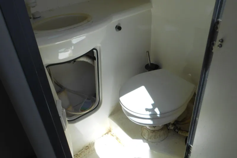 Slide: The Image of 2008 Bayliner 300 boat bathroom with toilet and sink. - 15