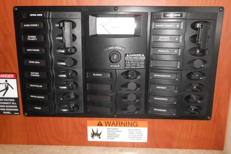 Slide: The Image of Electrical control panel on a 2008 Bayliner 300 boat with various switches and warnings. - 17