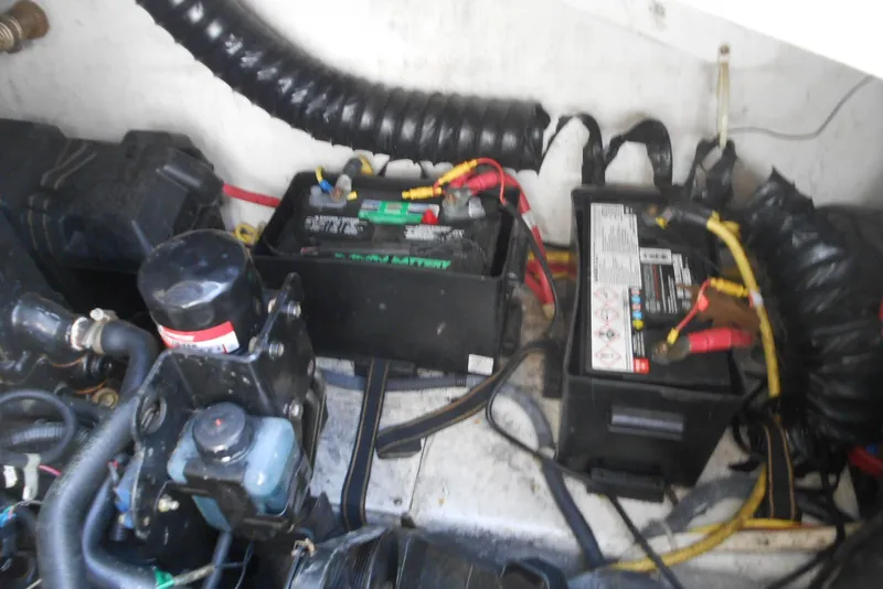 Slide: The Image of Engine compartment of a 2008 Bayliner 300 with visible batteries and wiring. - 18