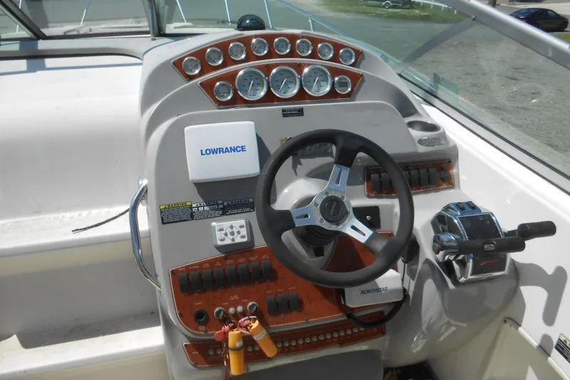 Slide: The Image of 2008 Bayliner 300 boat dashboard with steering wheel and control panel. - 3