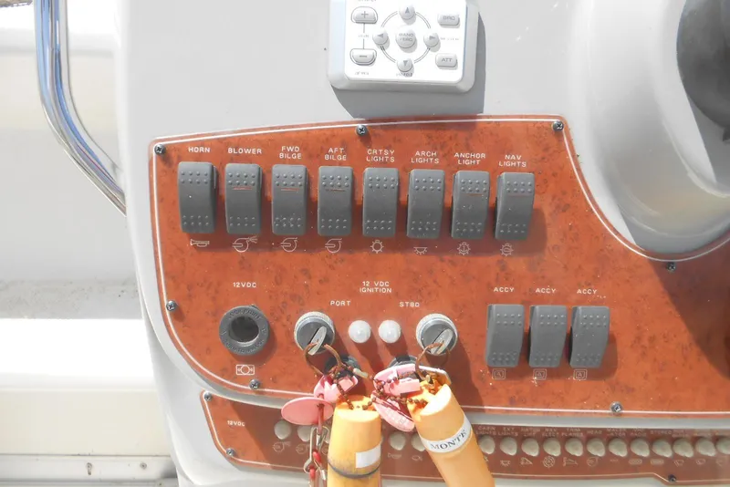 Slide: The Image of Control panel of a 2008 Bayliner 300 boat with switches and ignition keys. - 4