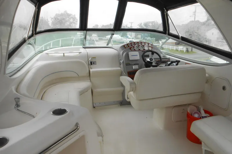 Slide: The Image of 2008 Bayliner 300 boat interior with steering wheel, dashboard, and seating area. - 6