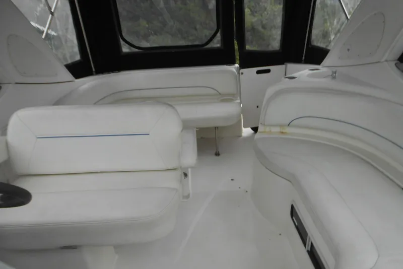 Slide: The Image of Interior of 2008 Bayliner 300 boat with white seating and enclosed cabin. - 7