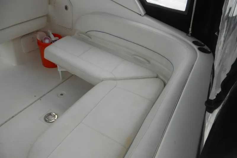 Slide: The Image of 2008 Bayliner 300 boat interior with white seating and storage area. - 8