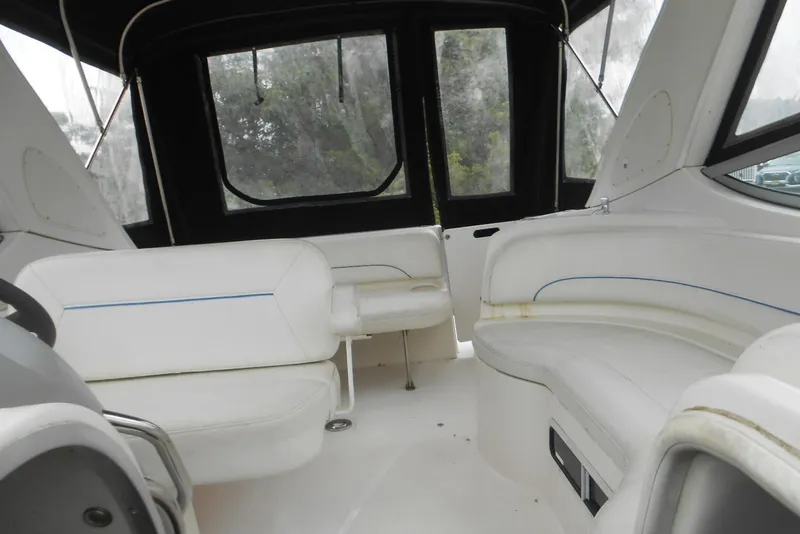 Slide: The Image of Interior of a 2008 Bayliner 300 boat with white seating and windows. - 9