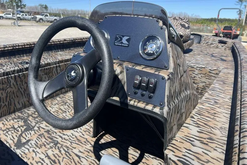 Slide: The Image of 2025 Xpress XP180 boat interior with camo design, steering wheel, and control panel. - 11