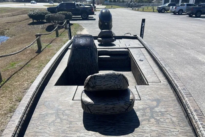 Slide: The Image of 2025 Xpress XP180 boat with camouflage interior, parked outdoors. - 5