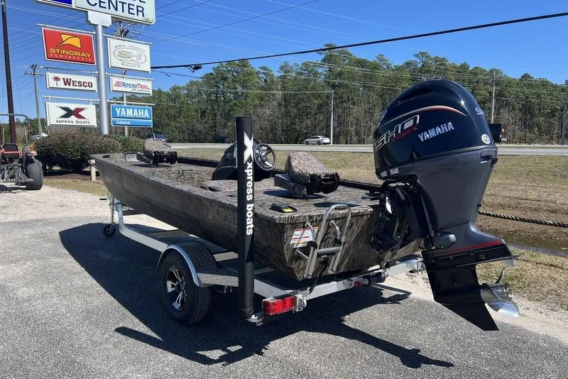 Slide: The Image of 2025 Xpress XP180 boat with Yamaha engine on trailer at dealership. - 6