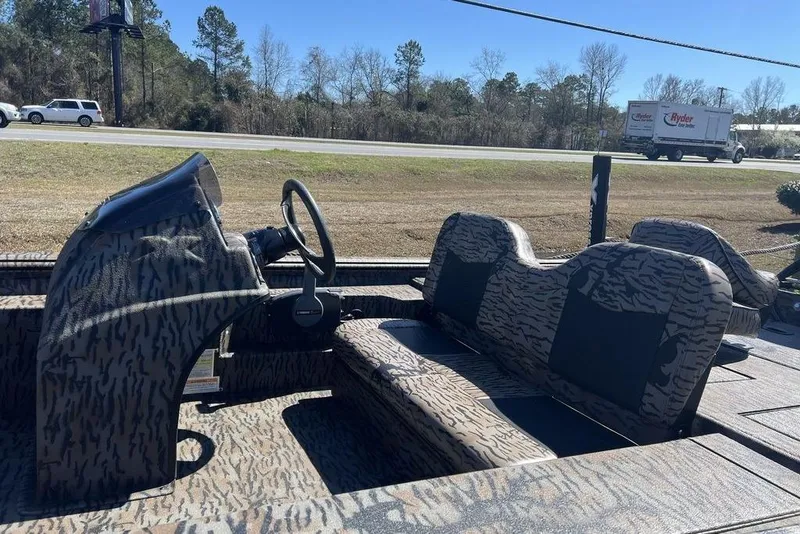 Slide: The Image of 2025 Xpress XP180 boat interior with camouflage design and steering wheel. - 9