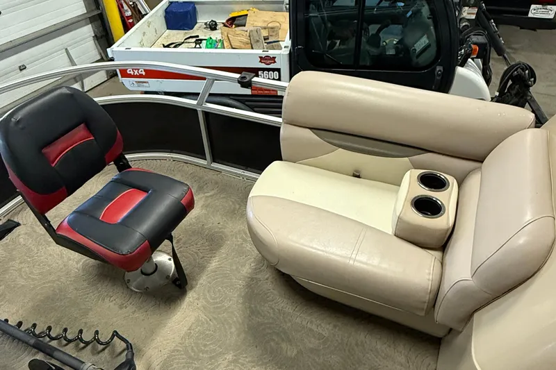 Slide: The Image of 2014 Sun Tracker Fishin' Barge 20 DLX interior with seating and cup holders. - 10