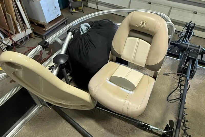 Slide: The Image of 2014 Sun Tracker Fishin' Barge 20 DLX seat in a garage setting. - 11
