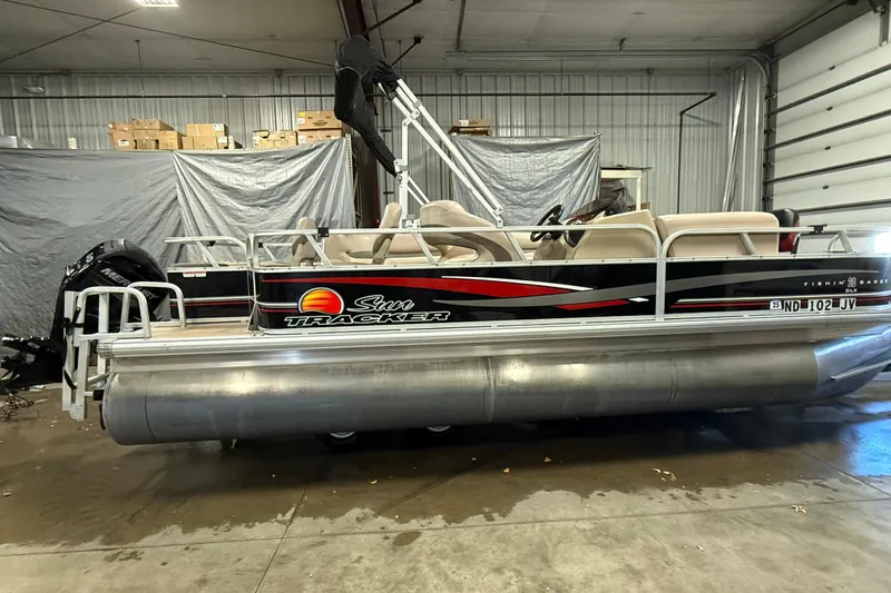 Slide: The Image of 2014 Sun Tracker Fishin' Barge 20 DLX pontoon boat in a garage setting. - 5