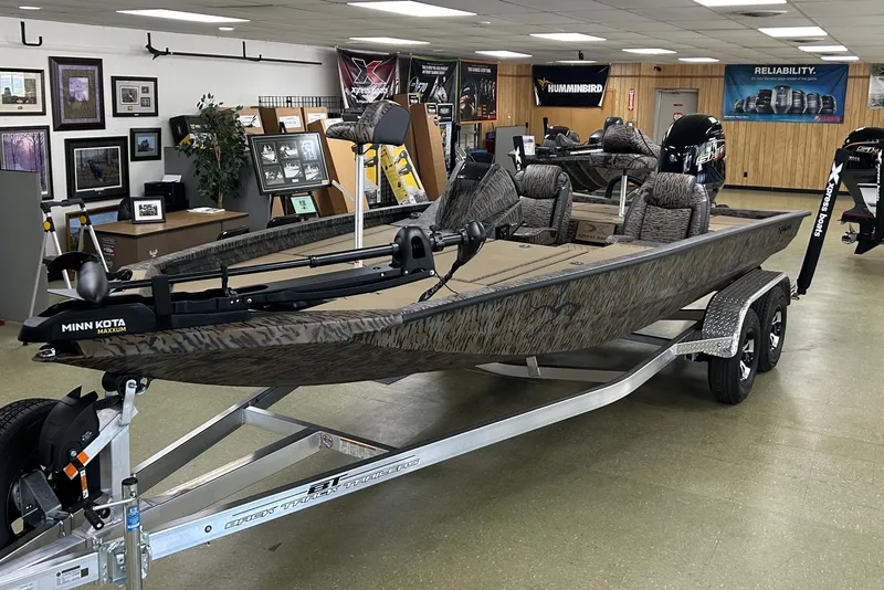 Slide: The Image of 2026 Xpress H20 Bass boat in showroom, featuring Minn Kota Maxxum trolling motor. - 0