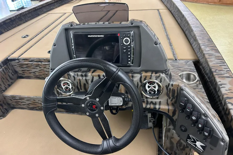 Slide: The Image of 2026 Xpress H20 Bass boat dashboard with steering wheel and control panel. - 2