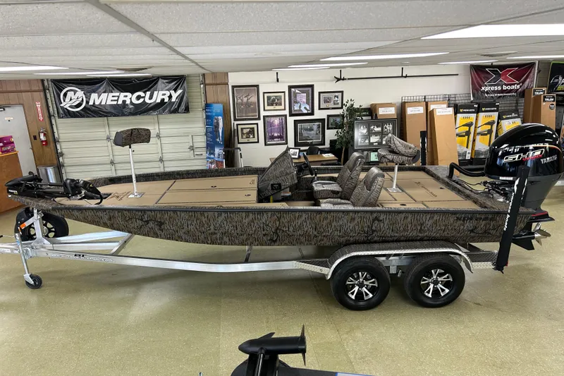 Slide: The Image of 2026 Xpress H20 Bass boat in showroom, featuring Yamaha engine and camouflage design. - 5
