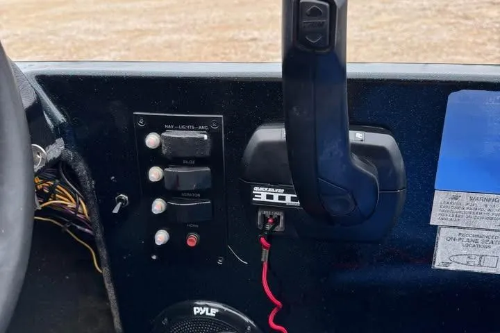 Slide: The Image of Control panel of a 1994 Nitro 170 DC boat with switches and throttle. - 12