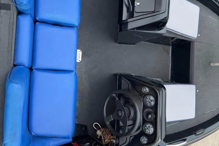 Slide: The Image of 1994 Nitro 170 DC boat interior with blue seating and steering console. - 13