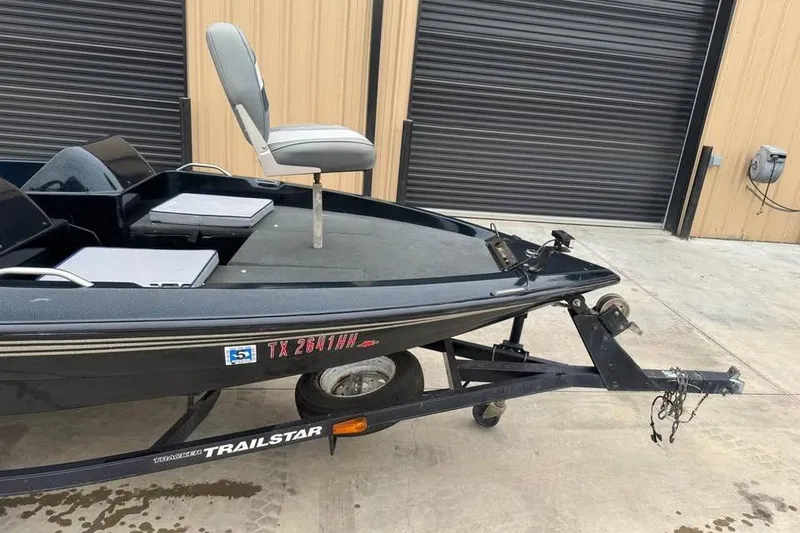 Slide: The Image of 1994 Nitro 170 DC boat on Trailstar trailer, parked near garage doors. - 5