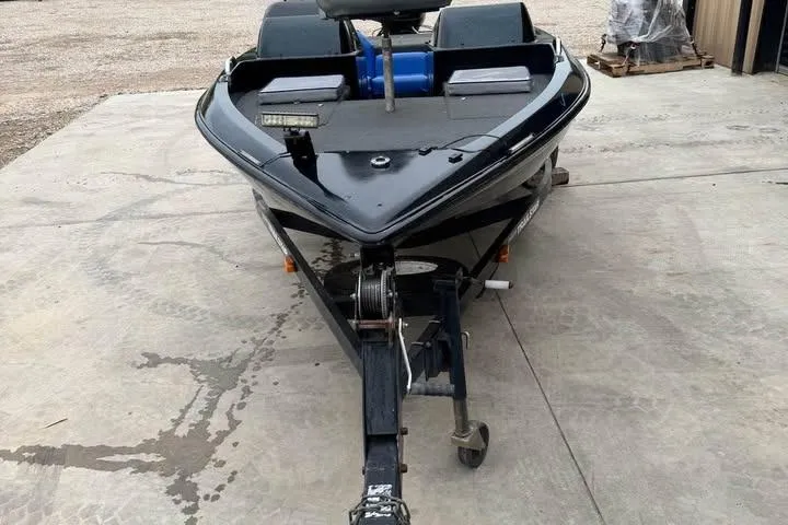 Slide: The Image of 1994 Nitro 170 DC boat on trailer, black exterior, parked on concrete surface. - 6