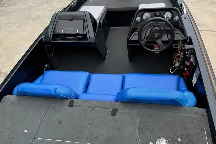 Slide: The Image of 1994 Nitro 170 DC boat interior with blue seating and steering console. - 7
