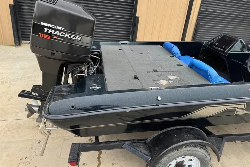 Slide: The Image of 1994 Nitro 170 DC boat with Mercury Tracker 115 outboard motor, parked on trailer. - 9
