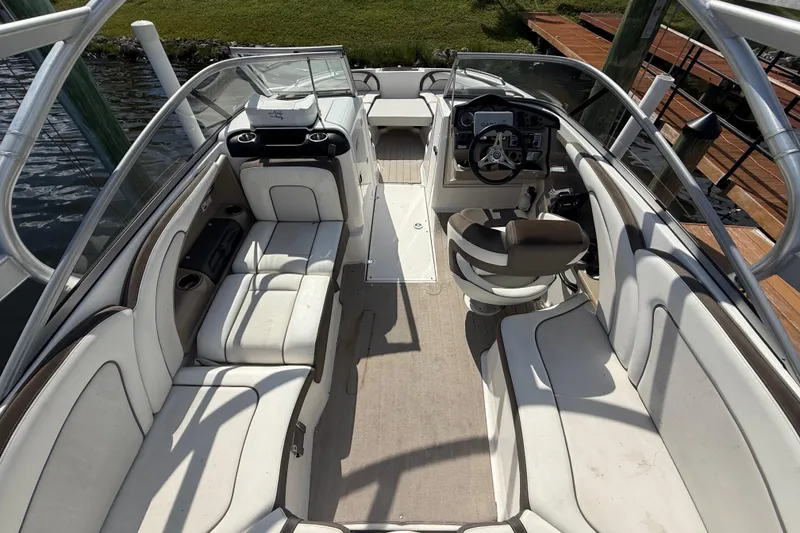 Slide: The Image of 2014 Yamaha Boats 242 Limited S interior with seating and steering console. - 12