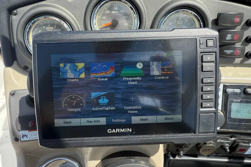 Slide: The Image of Garmin navigation system on 2014 Yamaha Boats 242 Limited S dashboard, displaying charts and sonar. - 16