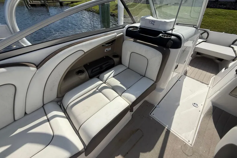 Slide: The Image of 2014 Yamaha Boats 242 Limited S interior with white seating and cup holders. - 18