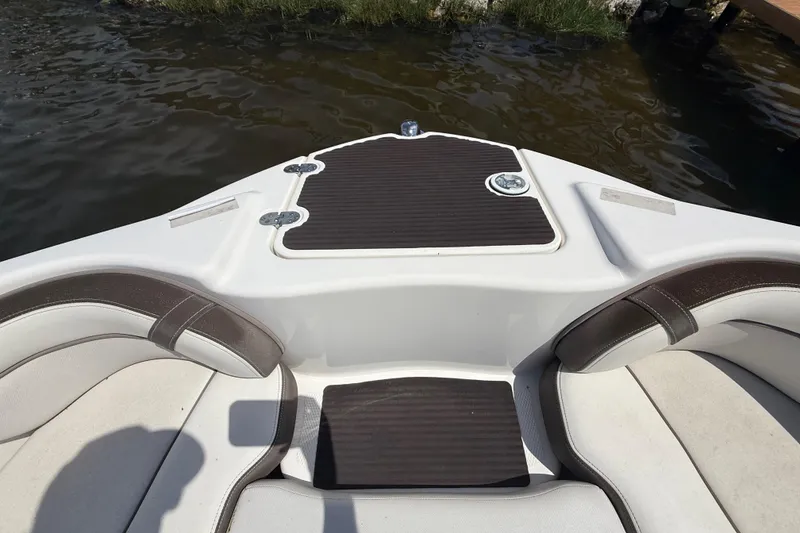 Slide: The Image of 2014 Yamaha Boats 242 Limited S interior seating and deck, near water. - 33
