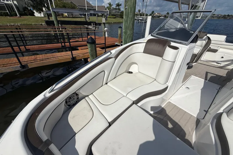 Slide: The Image of 2014 Yamaha Boats 242 Limited S interior with white seating and waterfront view. - 36