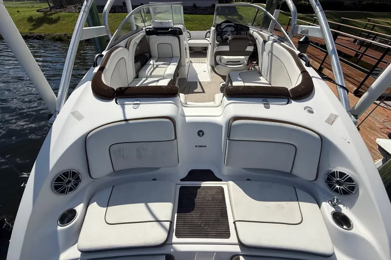 Slide: The Image of 2014 Yamaha Boats 242 Limited S interior with white seating and sleek design. - 4