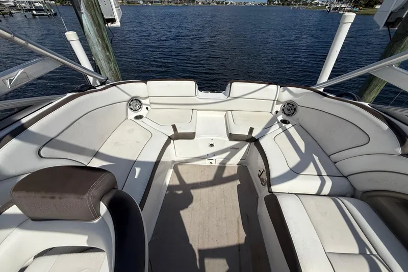Slide: The Image of 2014 Yamaha Boats 242 Limited S interior with white seating and water view. - 42