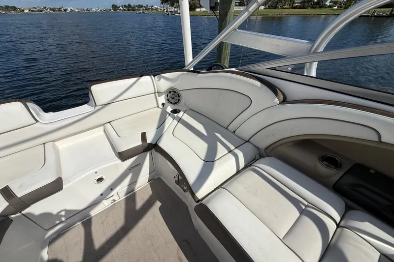 Slide: The Image of 2014 Yamaha Boats 242 Limited S interior with white seating, overlooking calm waters. - 43