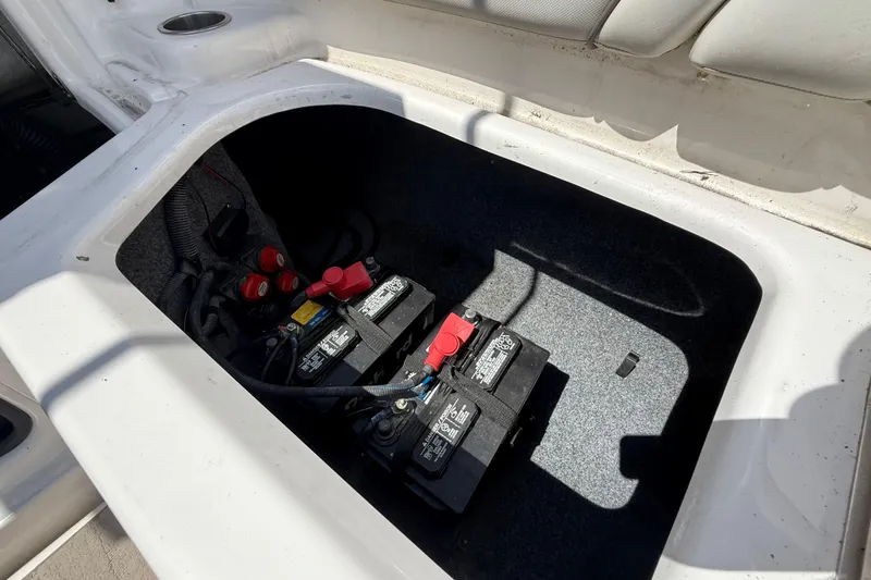 Slide: The Image of 2014 Yamaha Boats 242 Limited S battery compartment with dual batteries and wiring. - 44