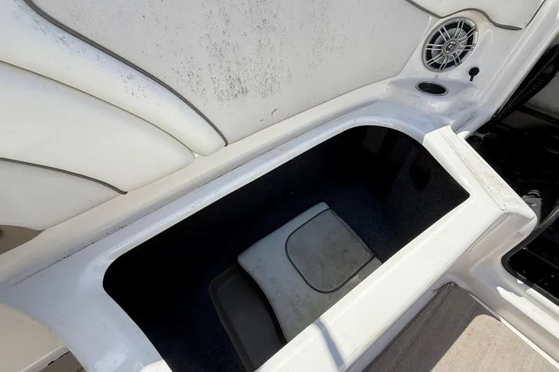 Slide: The Image of 2014 Yamaha Boats 242 Limited S interior storage compartment with speaker and cup holder. - 46