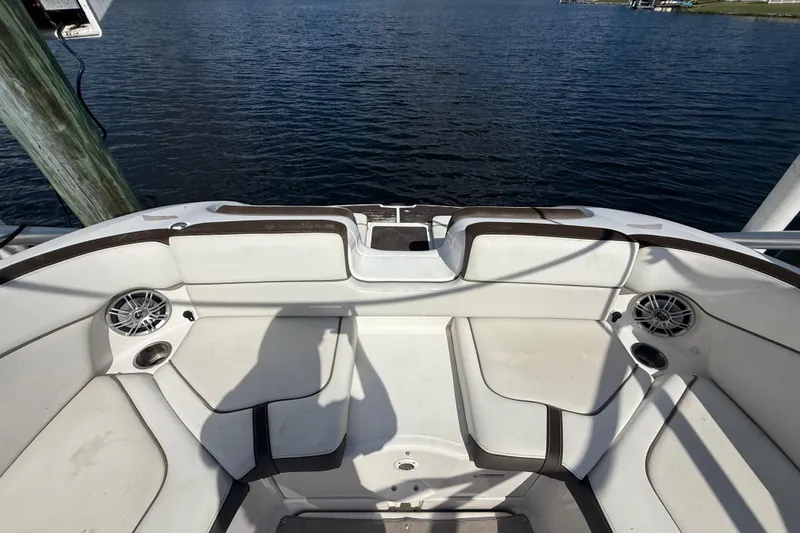 Slide: The Image of 2014 Yamaha Boats 242 Limited S interior seating with speakers, overlooking calm water. - 47